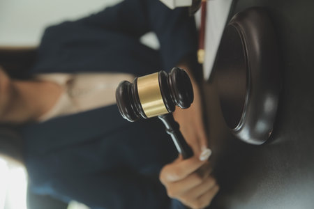 Judge gavel with Justice lawyers having team meeting at law firm background. Concepts of Law and Legal services.の写真素材