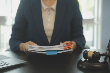 Judge gavel with Justice lawyers having team meeting at law firm background. Concepts of Law and Legal services.の写真素材