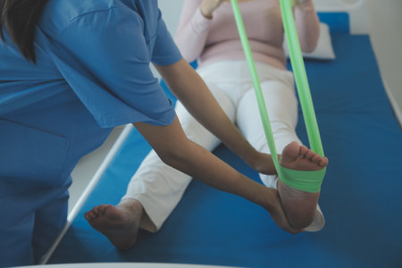 Patient doing some special exercises under supervision in a roomの写真素材