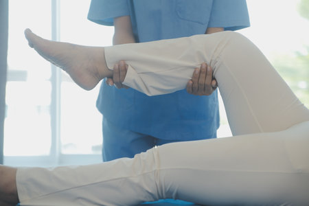 Patient doing some special exercises under supervision in a roomの写真素材