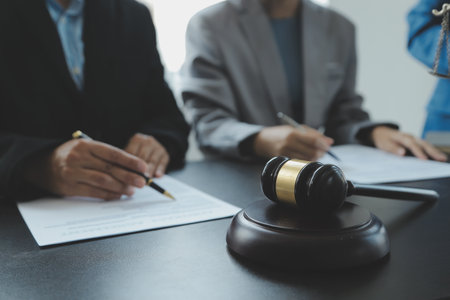 Business and lawyers discussing contract papers with brass scale on desk in office. Law, legal...