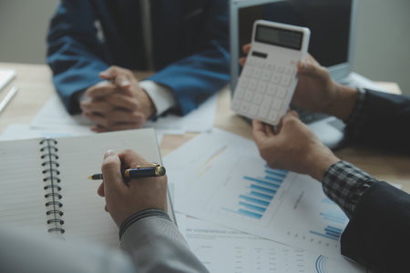 Group of confident business people point to graphs and charts to analyze market data, balance sheet,...