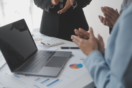 Financial analysts analyze business financial reports on a digital tablet planning investment...