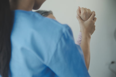 Doctor or physical therapist examines back pain and spinal area to give advice within the rehabilitation center.の写真素材