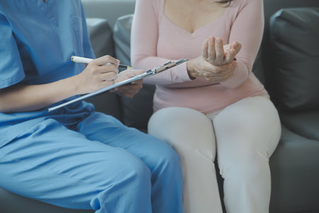 PTSD Mental health concept, Psychologist sitting and touch hand young depressed asian man for encouragement near window with low light environment.Selective focus.の写真素材