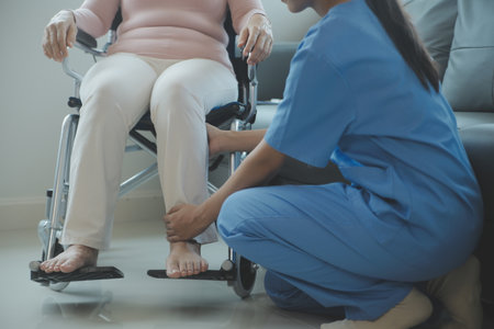 Asian young woman nurse at nursing home take care disabled senior man. Caregiver doctor serve physical therapy for older elderly patient to exercise and practice walking on walker or cane at backyard.の写真素材