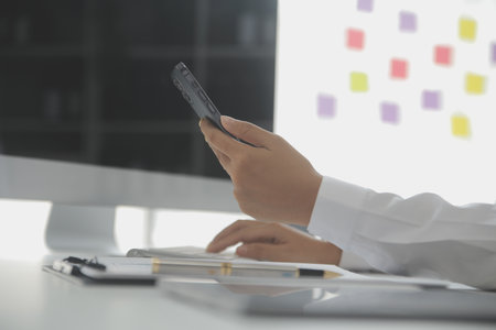 Group of confident business people point to graphs and charts to analyze market data, balance sheet, account, net profit to plan new sales strategies to increase production capacity.の写真素材