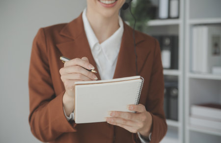 Young friendly operator woman agent with headsets working in a call centre.の写真素材