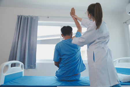 Patient doing some special exercises under supervision in a roomの写真素材