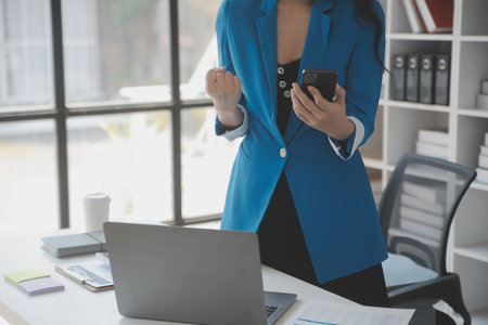 Financial analysts analyze business financial reports on a digital tablet planning investment project during a discussion at a meeting of corporate showing the results of their successful teamwork.の写真素材