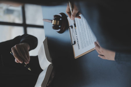 Business and lawyers discussing contract papers with brass scale on desk in office. Law, legal...