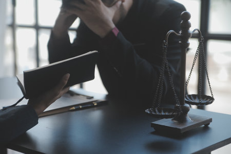Business and lawyers discussing contract papers with brass scale on desk in office. Law, legal...