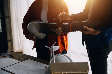 Professional Mechanical Engineer team Working on Personal Computer at Metal lathe industrial manufacturing factory. Engineer Operating lathe Machinery. Product quality Inspectionの写真素材