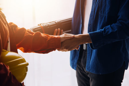 Professional Mechanical Engineer team Working on Personal Computer at Metal lathe industrial manufacturing factory. Engineer Operating lathe Machinery. Product quality Inspectionの写真素材