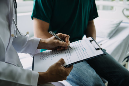 Male patient having consultation with doctor or psychiatrist who working on diagnostic examination on men's health disease or mental illness in medical clinic or hospital mental health service centerの写真素材