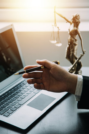 Business and lawyers discussing contract papers with brass scale on desk in office. Law, legal services, advice, justice and law concept picture with film grain effectの写真素材