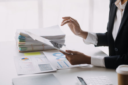 Businesswoman or accountant working Financial investment on calculator, calculate, analyze business and marketing growth on financial document data graph, Accounting, Economic, commercial concept.の写真素材