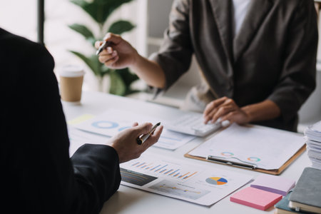 Businesswoman or accountant working Financial investment on calculator, calculate, analyze business and marketing growth on financial document data graph, Accounting, Economic, commercial concept.の写真素材
