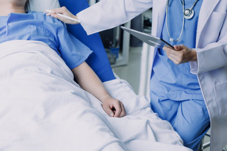 Doctor telling to patient woman the results of her medical tests. Doctor showing medical records to cancer patient in hospital ward. Senior doctor explaint the side effects of the intervention.の写真素材