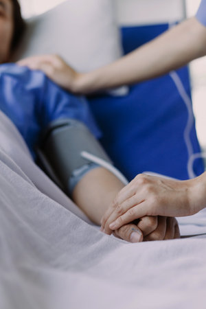 doctor check up after surgery. doctor touching patient hand and consoling.の写真素材