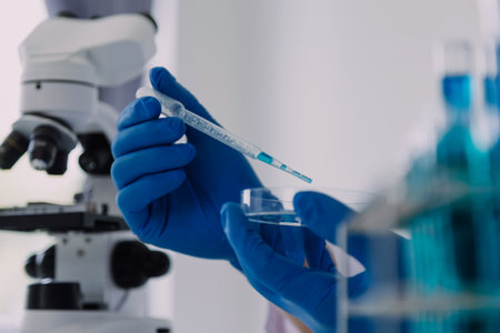 Medical Development Laboratory: Caucasian Female Scientist Looking Under Microscope, Analyzes Petri...