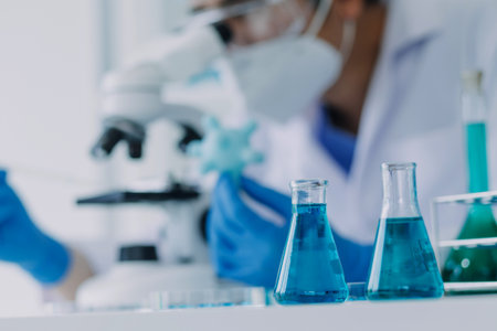hand of scientist with test tube and flask in medical chemistry lab blue banner background