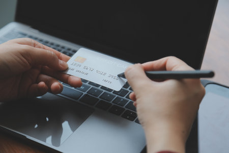 Women holding credit card and using smartphones at home.Online shopping, internet banking, store online, payment, spending money, e-commerce payment at the store, credit card, conceptの写真素材