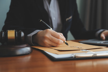 Business and lawyers discussing contract papers with brass scale on desk in office. Law, legal services, advice, justice and law concept picture with film grain effectの写真素材