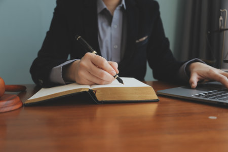 Business and lawyers discussing contract papers with brass scale on desk in office. Law, legal...