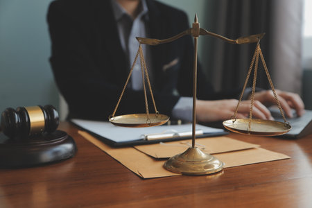 Business and lawyers discussing contract papers with brass scale on desk in office. Law, legal...