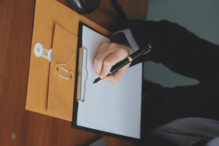 Business and lawyers discussing contract papers with brass scale on desk in office. Law, legal...