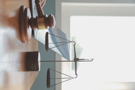Business and lawyers discussing contract papers with brass scale on desk in office. Law, legal services, advice, justice and law concept picture with film grain effectの写真素材