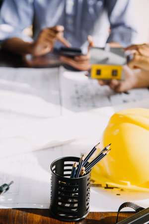 architect man working with laptop and blueprints,engineer inspection in workplace for architectural plan,sketching a construction project ,selective focus,Business concept vintage colorの写真素材