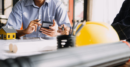 architect man working with laptop and blueprints,engineer inspection in workplace for architectural...