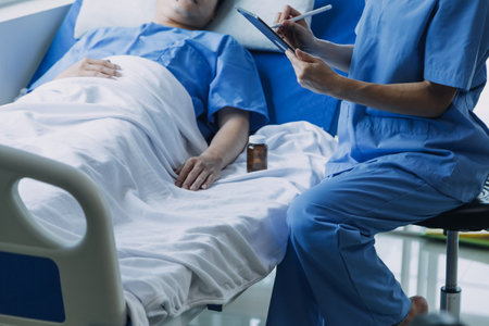 Asian caregiver doctor examine older patient use blood pressure gauge. Young woman therapist nurse at nursing home taking care of senior elderly woman sit on sofa. Medical insurance service conceptの写真素材