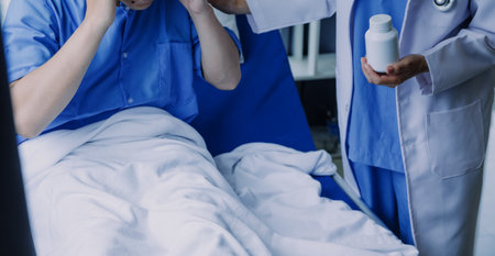 Asian caregiver doctor examine older patient use blood pressure gauge. Young woman therapist nurse at nursing home taking care of senior elderly woman sit on sofa. Medical insurance service conceptの写真素材