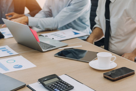Financial analysts analyze business financial reports on a digital tablet planning investment...