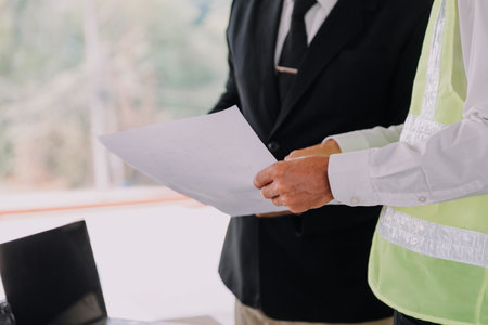 Professional Mechanical Engineer team Working on Personal Computer at Metal lathe industrial manufacturing factory. Engineer Operating lathe Machinery. Product quality Inspectionの写真素材