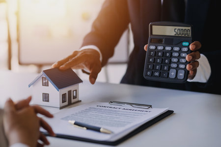 Accountant, businessman, real estate agent, Asian business woman handing keys to customers along with house after customers to signの写真素材