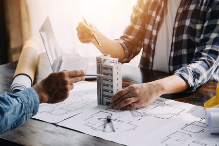 Engineer Teamwork Meeting, Drawing working on blueprint meeting for project working with partner on model building and engineering tools in working site, Construction and structure concept.の写真素材