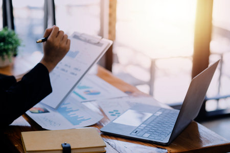 Close up of accountant working and analyzing financial reports project accounting with chart graph...