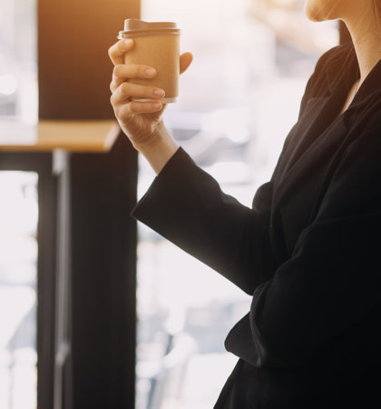 Asian Business woman using calculator and laptop for doing math finance on an office desk, tax, report, accounting, statistics, and analytical research conceptの写真素材