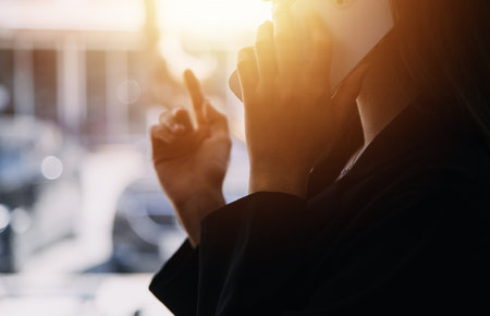 Asian Business woman using calculator and laptop for doing math finance on an office desk, tax, report, accounting, statistics, and analytical research conceptの写真素材