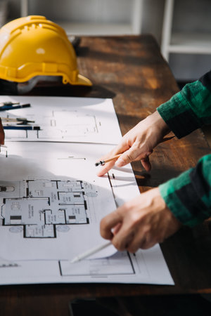 Construction and structure concept of engineer working drawing on blueprint meeting for project...