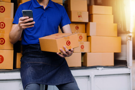 Starting small businesses SME owners man entrepreneurs working, box and check online orders to...