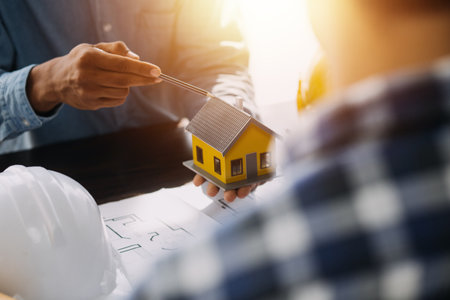 Engineer Teamwork Meeting, Drawing working on blueprint meeting for project working with partner on model building and engineering tools in working site, Construction and structure concept.の写真素材