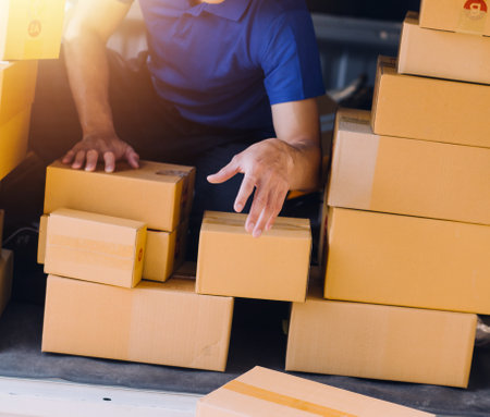 Starting small businesses SME owners man entrepreneurs working, box and check online orders to prepare to pack the boxes, sell to customers, sme business ideas online.の写真素材