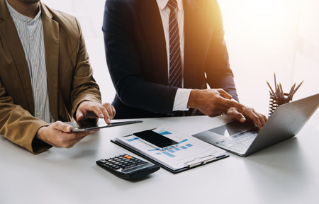 Close up Business woman using calculator and laptop for do math finance on wooden desk, tax, accounting, statistics and analytical research conceptの写真素材