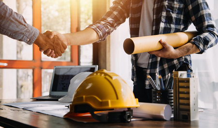 Construction and structure concept of engineer working drawing on blueprint meeting for project working with partner on model building and engineering tools in working site, construction concept.の写真素材