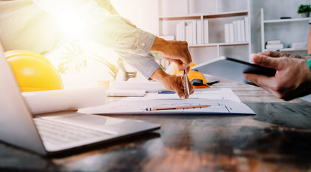 Construction and structure concept of Engineer or architect meeting for project working with partner and engineering tools on model building and blueprint in working site, contract for both companies.の写真素材
